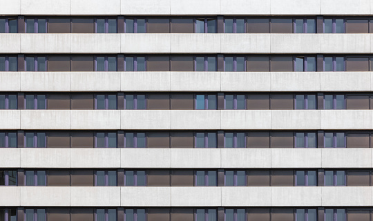Building facade with repeating pattern of geometric windows