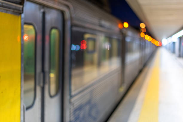 railway station with left side train carriages and in -depth corridor on the right side with blurred image