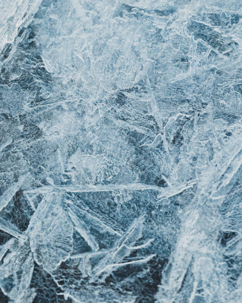 istock cracked ice close up, deep frozen lake blue ice texture, repeating pattern 1392903710