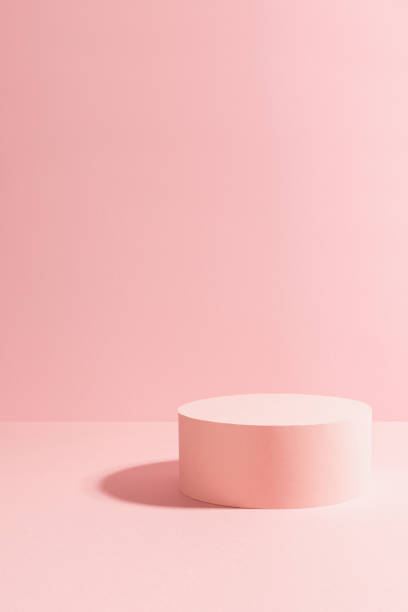 istock Bright pastel pink single circle podium in sunlight with shadow mockup for presentation cosmetic product or goods, copy space, vertical. Romantic template for advertising, design, show, display. 1392904446