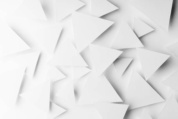 istock White paper triangles as abstract geometric texture in bright light with soft light shadows, top view. Simple tender purity dynamic mosaic background in minimal style. 1392904493