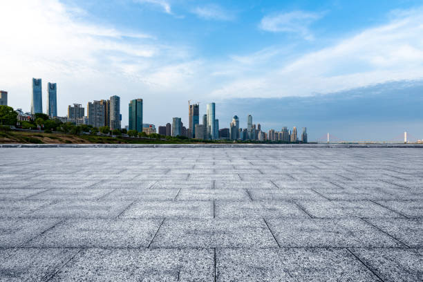 istock Monotone grey masonry perspective and cityscape on road pavement 1392904844