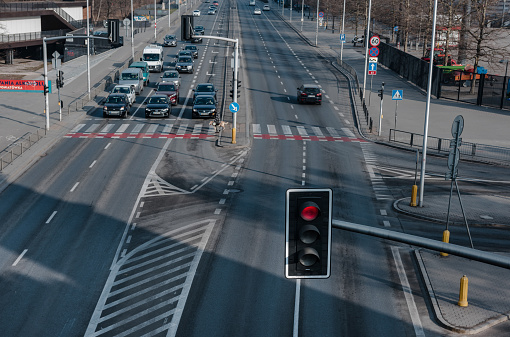 Warsaw. Poland. 03.30.2022. Crossroads with traffic lights. Cars are waiting to pass.