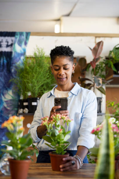 istock Front view new business owner using smart phone in store 1392911106