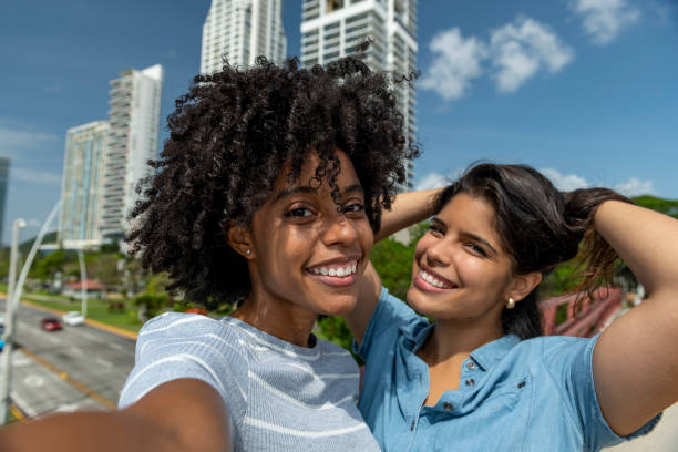 istock Young latin women taking selfie with mobile phone 1392911245