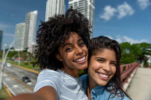 Young latin women taking selfie with mobile phone in Panama city, Panama