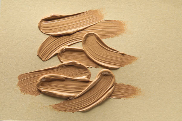 istock Sample of liquid skin foundation on beige background, top view 1392915286