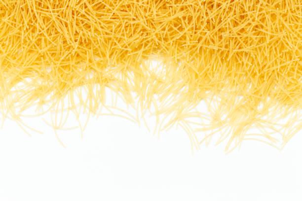 Uncooked vermicelli pasta on white background. Raw dry filini vermicelles. stock photo