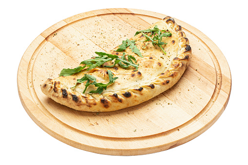 Traditional closed italian pizza calzone on wooden plate  isolated on white background. File contains clipping path. Concept for advertising flyer and poster for restaurants or pizzerias.