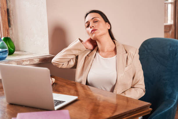 istock Psychologist closed her eyes and rubbing her neck after hard work day 1392916671