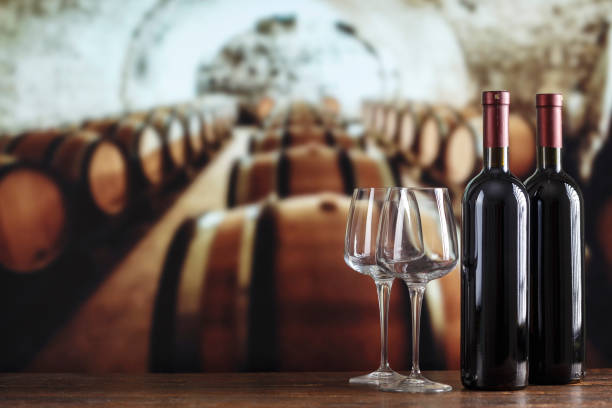 istock Wine cellar with wine bottle and glasses. Red wine tasting in the wine cellar. 1392916965