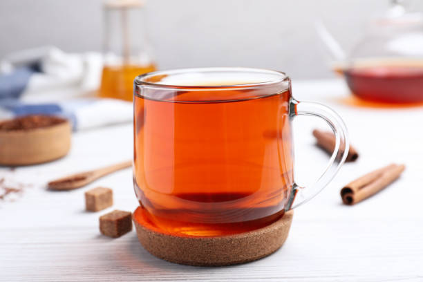 istock Freshly brewed rooibos tea on white wooden table 1392917076