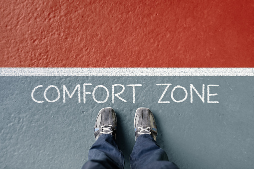 Man standing in his comfort zone missing out on opportunity concept for motivation, opportunity and possitive attitude