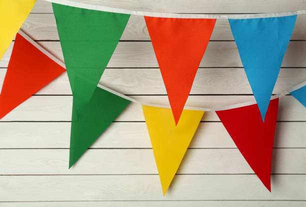 istock Buntings with colorful triangular flags on white wooden background 1392917776