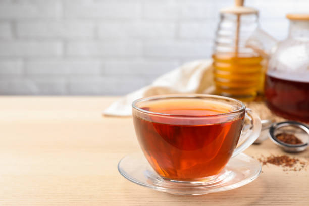 istock Freshly brewed rooibos tea on wooden table. Space for text 1392917802