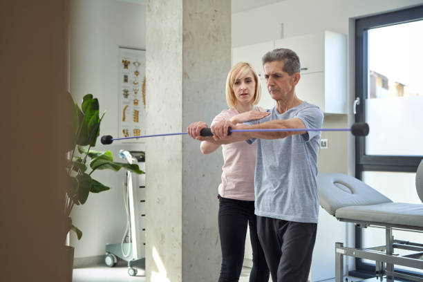 istock Female physical therapist working with senior man about his balance 1392917870