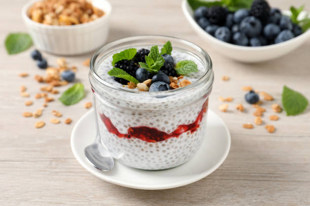 istock Delicious chia pudding with berries and granola on wooden table 1392918389