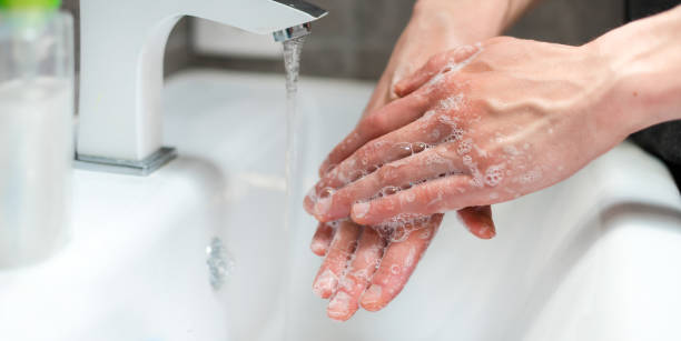 istock close up. modern guy carefully lathering his hands 1392918465