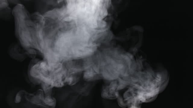 Moving white vapor stream on a black background.