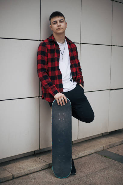 istock Teenage boy with skateboard 1392921700