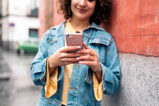 istock Beautiful Young Woman Using Phone 1392922687