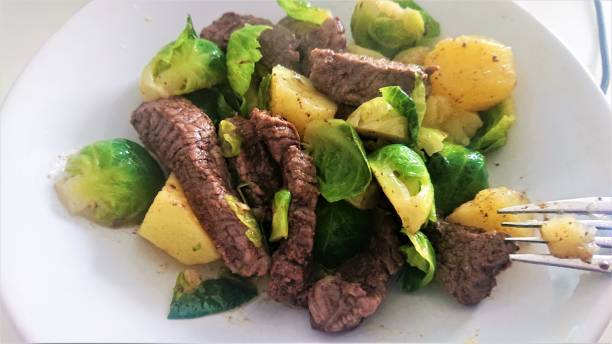 Beef with potatoes and sprouts.