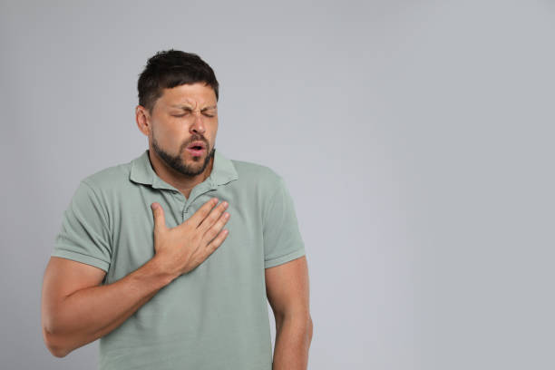 istock Man suffering from pain during breathing on grey background, space for text 1392923673