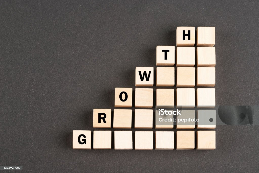 Wooden block cubes with arrows Wooden block cubes with word Growth on black background Single Word Stock Photo