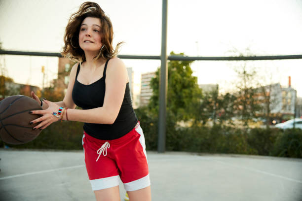 istock A young woman makes a shot in a game. 1392926629