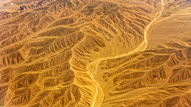 istock Desert mountains with dry riverbed 1392927093
