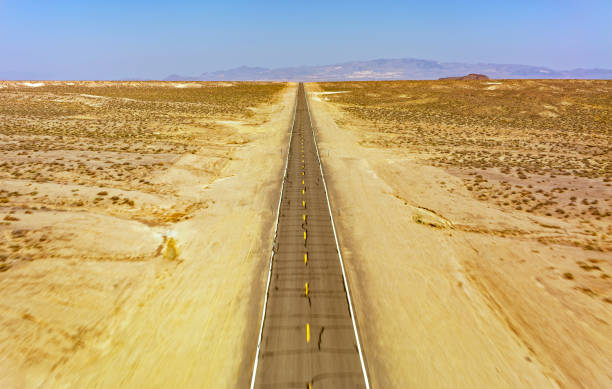 istock Desert road in landscape 1392927103
