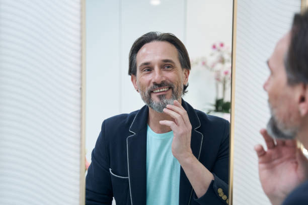 istock Close up of happy man looking at his reflection 1392928092