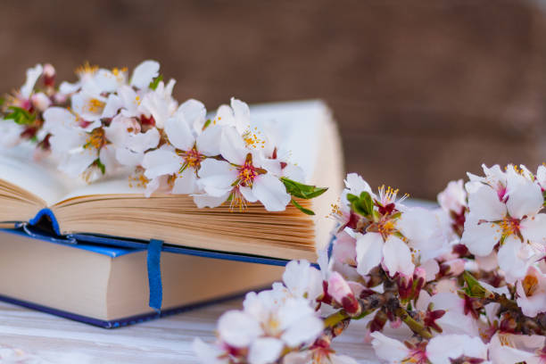istock close-up open book on the table with flowering almond branches 1392928342