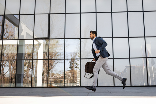 Business man running to office