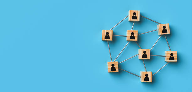 istock Wooden blocks with a people icon on a blue background with copy space. 1392932987