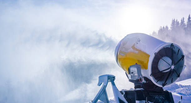 istock Snow cannon in winter mountains. Snow-gun spraying artificial ice crystals. Machine making snow. 1392933256