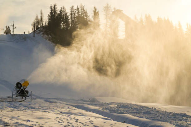 istock Snow cannon in winter mountains. Snow-gun spraying artificial ice crystals. Machine making snow. 1392933266
