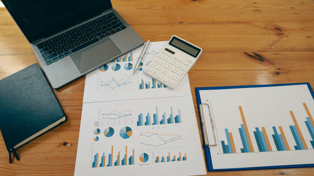 istock front view on business desk with laptop computer and graph document calculator and equipment lay flat with copy space business finance office concept 1392936900