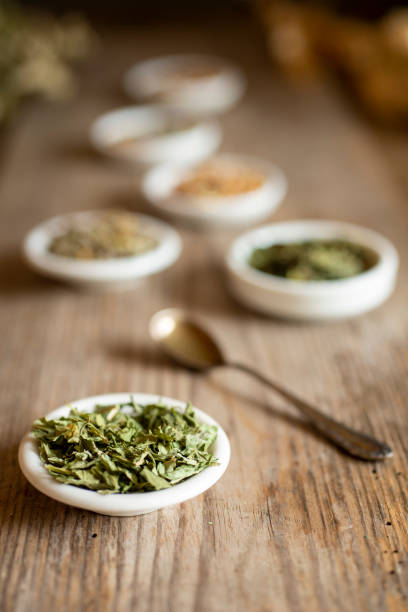 Different kinds of tea or herbs on an old table