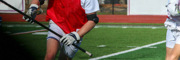 Lacrosse player running whith the ball during a scrimmage stock photo