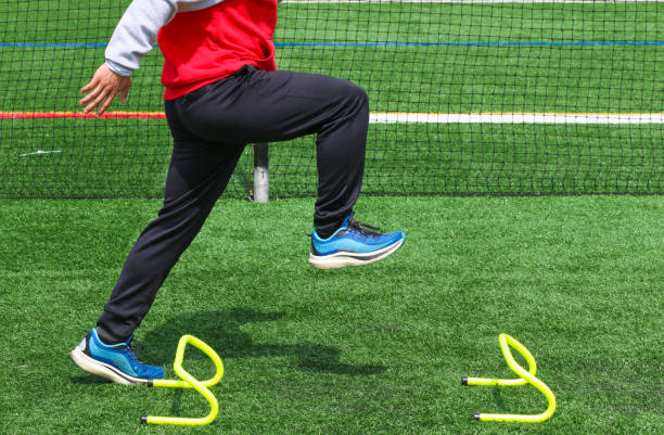 istock Runner in the track A position standing over a small yellow hurdle 1392937878