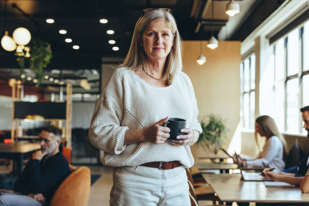 istock Mature businesswoman standing in a co-working space 1392938500