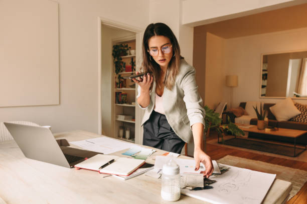 istock Young interior designer speaking over the phone in her home office 1392938650