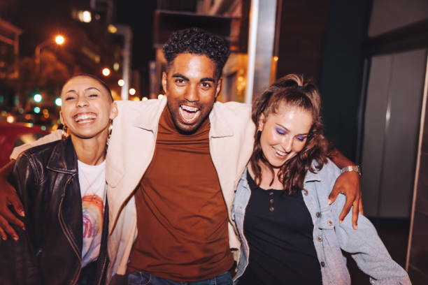istock Three friends having fun in the city at night 1392938843