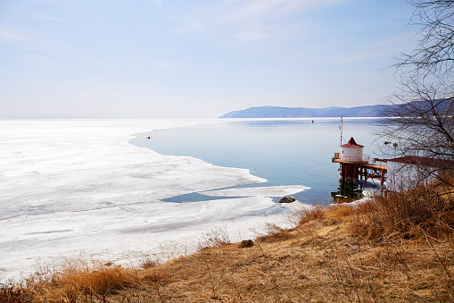 Lake Baikal in the spring. Ice floes and open water. The Village Of Listvyanka.