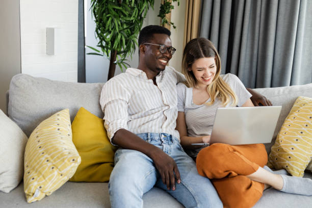 istock Portrait of a happy couple using laptop 1392942189