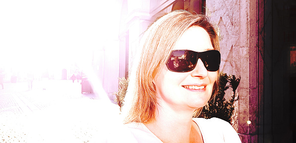 Portrait of woman with sunglasses and lens flare