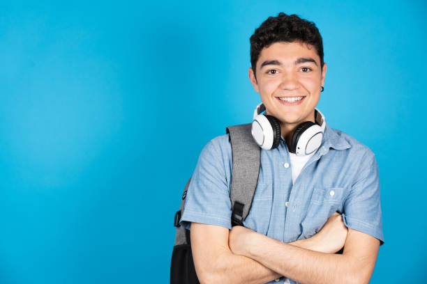 istock Hispanic student teenager boy looking at camera 1392943635