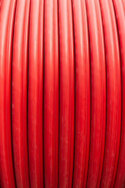 istock Red wire cable in reels close up on coil 1392948099