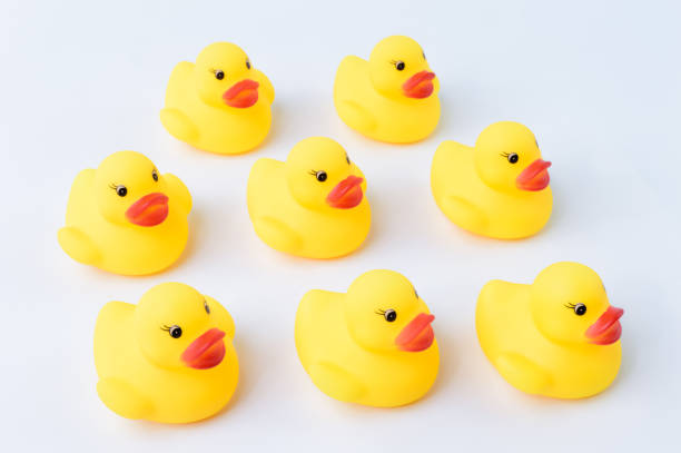 istock Group of toy ducks standing together. Teamwork and togetherness concept. 1392948132